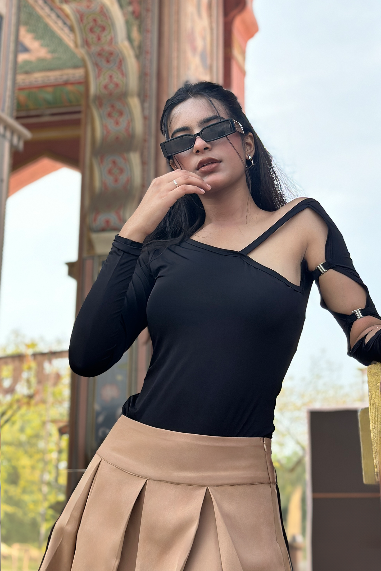 Ronazen black cut-out top, featuring elegant cut-out details along the shoulders and sides. The top is fitted, showcasing a contemporary and stylish design. The background is neutral, emphasizing the chic and versatile appeal of the garment, perfect for fashion-forward wardrobes